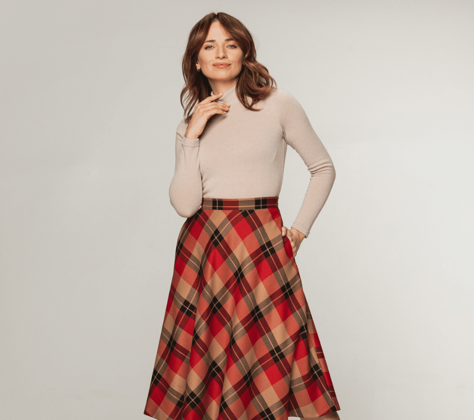 Wizualizacja kobiety w beżowym golfie z długim rękawem i rozkloszowanej spódnicy w kratę