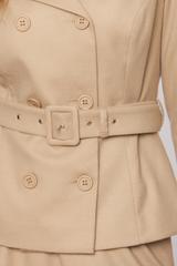 A beige double-breasted short jacket with a wide collar and a belt