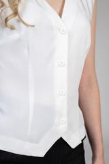 A lightweight ecru viscose blouse with a vest-style cut