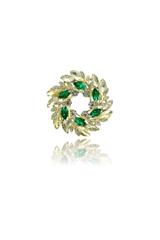 A stylish round gold brooch with green cubic zirconia stones
