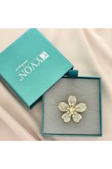 A gold flower brooch entirely set with cubic zirconia