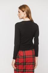 A black blouse with a deep wrap neckline and ruffles down the side