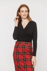 A black blouse with a deep wrap neckline and ruffles down the side