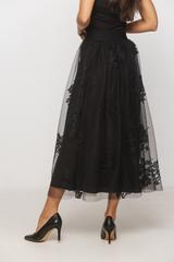 A black tulle skirt with a delicate floral pattern