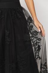 A black tulle skirt with a delicate floral pattern