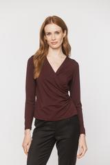 A burgundy knitted blouse with a wrap neckline and ruffles down the side