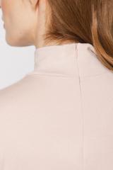 A powder-coloured, stretchy turtleneck made from a delicately ribbed knit