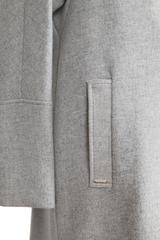 A simple woollen coat made from ash-grey textured fabric