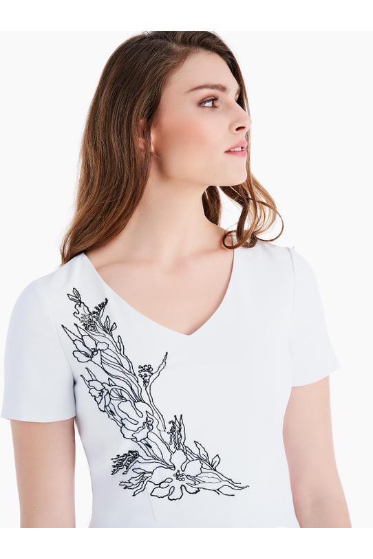 Bluzka ecru z baskinką i ozdobnym suwakiem z tyłu - 2