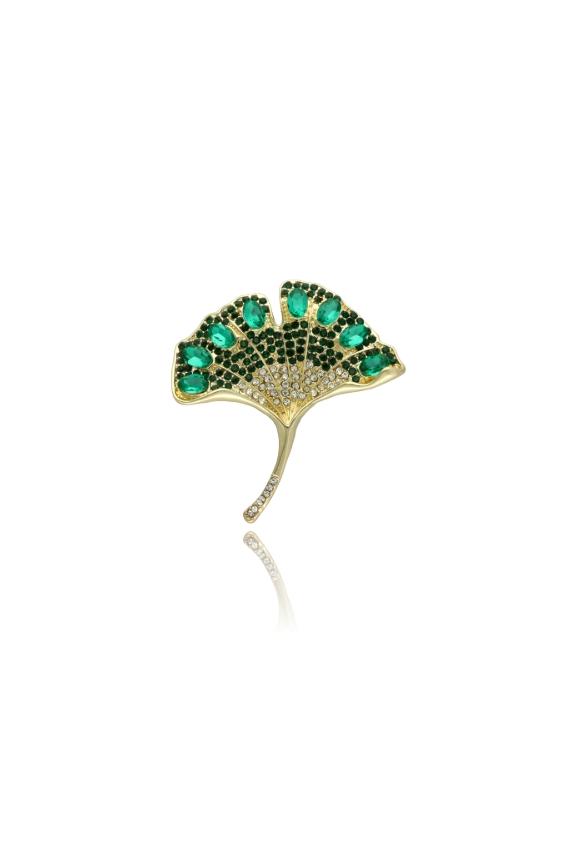 A gold brooch in the shape of a ginkgo leaf with green cubic zirconia stones
