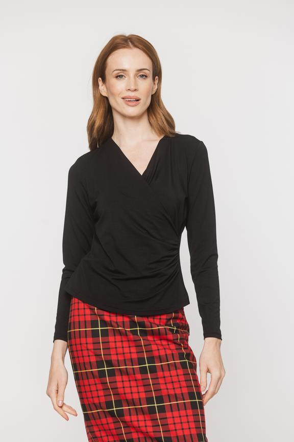 A black blouse with a deep wrap neckline and ruffles down the side