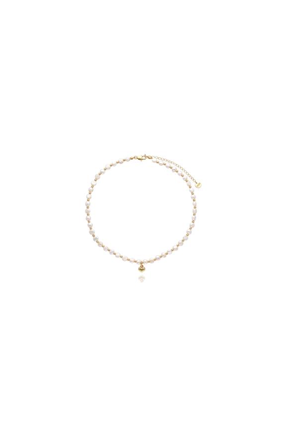 A necklace made of natural pearls with a gold heart pendant